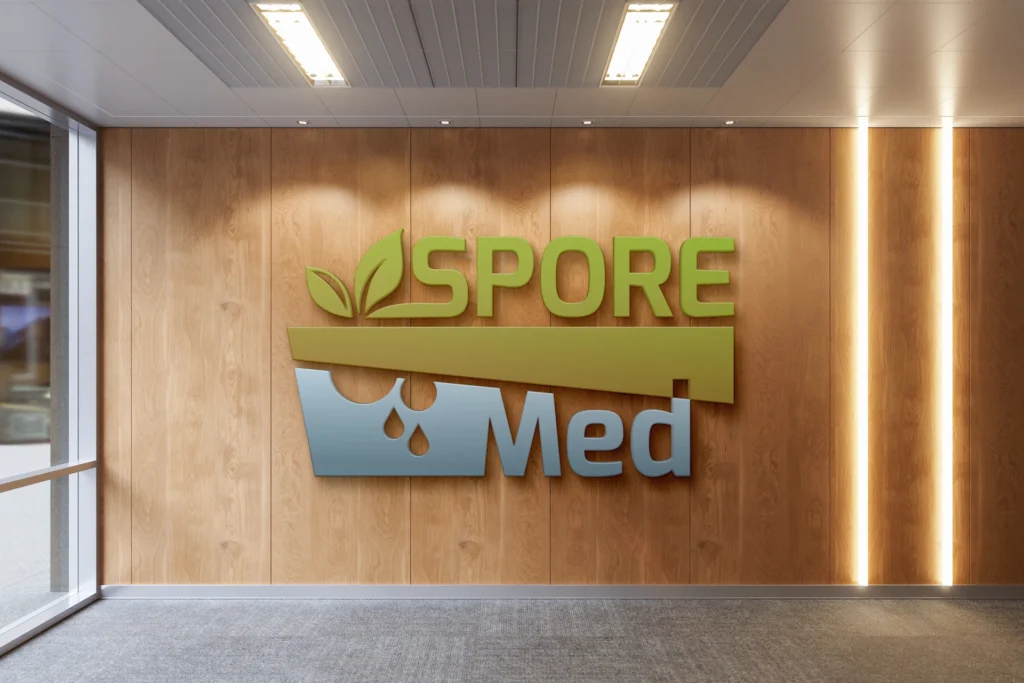 Logotip SPORE-MED aplicat a una paret interior